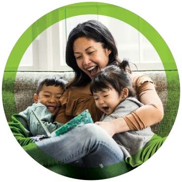 A parent sharing a happy moment at home with two children.